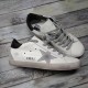 Golden Goose Super-Star White Trainer - Side Profile in white and grey Side profile of Golden Goose Super-Star white trainer showing metallic GGDB lettering and grey star