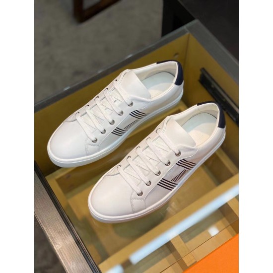 Hermes Avantage Leather Trainers Top View in white and blue Top view of pair of white and blue Hermes leather trainers on glass table