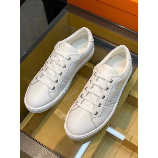 Top-down perspective of the pair of white leather trainers