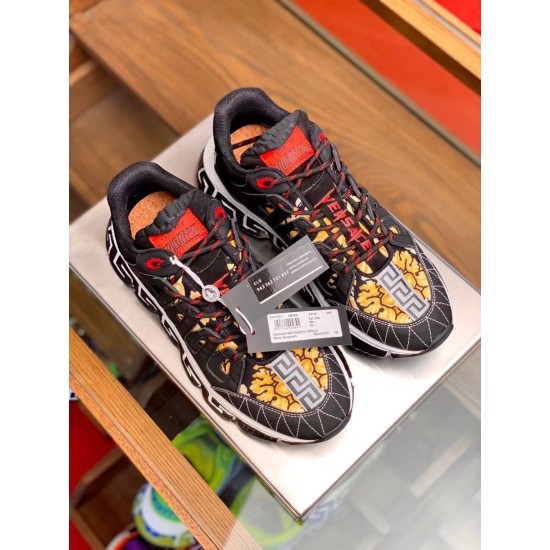 Versace Trigreca Black Trainers Top-Down View in black and yellow Pair of black Barocco print trainers viewed from above with attached brand identity tags in black and yellow
