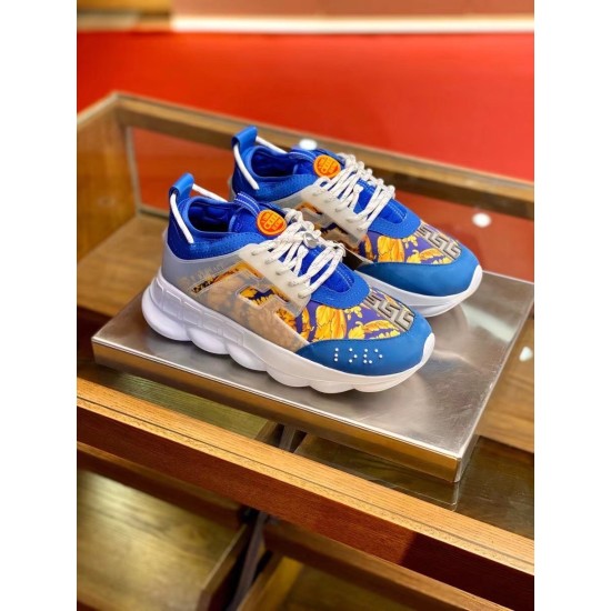Three-quarter elevated angle of blue and yellow baroque Versace Chain Reaction trainers on display