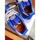 Versace Chain Reaction Blue Trainer Interior Detail in blue and white Close-up of the tongue badge and orange inner sole of a blue Versace trainer in blue and white