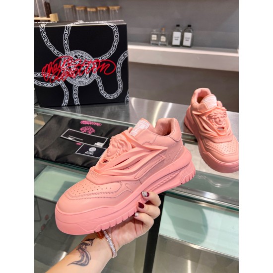 Hand held view showing the lateral profile of the pink Versace Odissea leather trainer