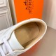 Hermes Boomerang Trainer Tan Leather Interior Detail in white Close-up interior view of the tan leather lining and foil logo print inside the Hermes Boomerang trainer in white