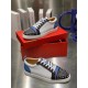 Christian Louboutin Louis Junior Spikes Orlato Angled Pair in white and blue Angled view of white and blue Christian Louboutin Louis Junior Spikes Orlato trainers with shoe box background