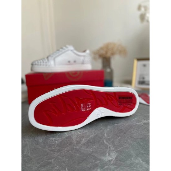 Underside view of the trainer displaying the signature Christian Louboutin red outsole in white and silver