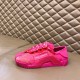 Dolce & Gabbana fuchsia pink lace slip-on trainer rested on a leather bench surface