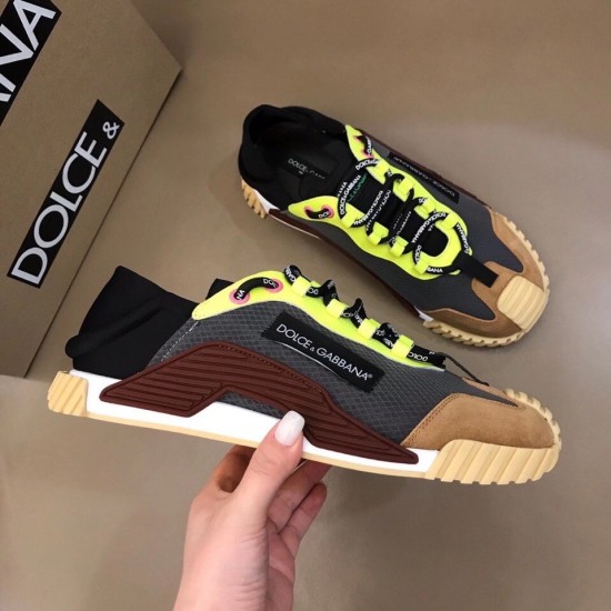 Dolce & Gabbana Grey Mesh Trainers Handheld View in grey and yellow Hand holding a Dolce & Gabbana grey and yellow mesh trainer alongside a second shoe