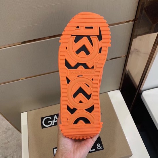 Underside view of the bright orange rubber sole showing deep tread geometry and Made in Italy lettering in orange and green