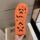 Underside view of the bright orange rubber sole showing deep tread geometry and Made in Italy lettering in orange and green