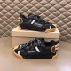 Pair of Dolce & Gabbana black fabric trainers displayed on top of box in black and tan