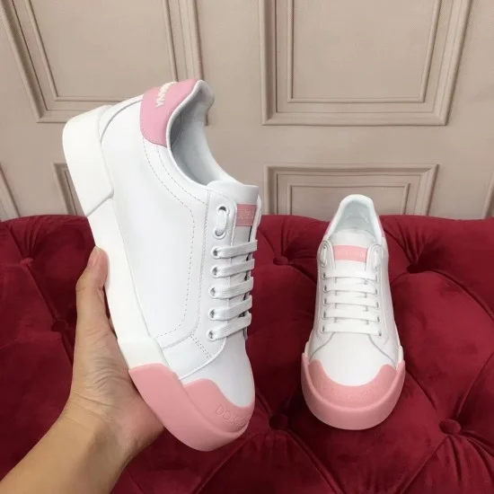 Dolce & Gabbana Portofino White Leather Trainers Handheld View in white and pink Dolce & Gabbana Portofino white leather trainers held up with pink toe-cap