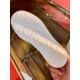 Underneath view showing ornate embossed tread detail on the white rubber sole in white and red