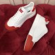 Overhead view of two white leather trainers showing clean insoles and red toe caps