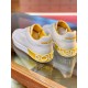 Rear Heel Detail on White and Yellow Trainers Rear angle view detailing yellow heel tabs with raised white logo lettering