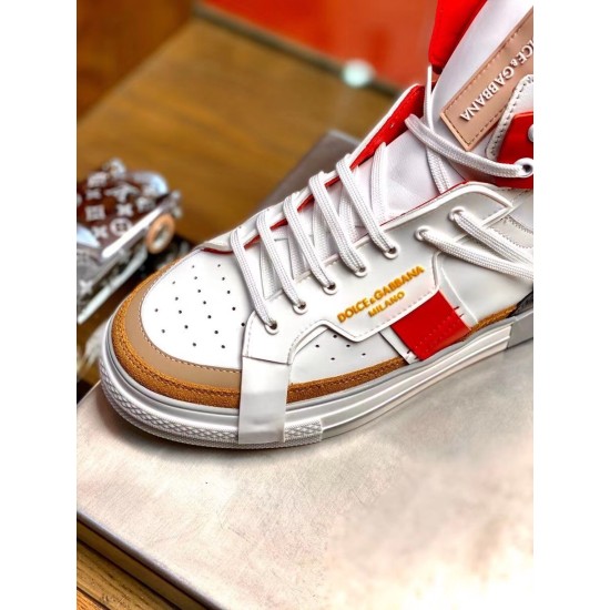 Close-up of gold-tone logo lettering on side panel and perforated toe of Dolce & Gabbana trainer in white and red
