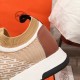 Hermes Addict Knit Trainers Heel Detail in beige and white Detailed close-up of the brown leather heel panel and knit stretch collar on Hermes Addict Knit Trainer in beige and white