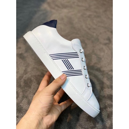 Hermes Avantage Leather Trainers In Hand in white and blue In-hand view of white leather trainer demonstrating side profile and sole in white and blue