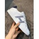Hermes Avantage Leather Trainers In Hand in white and blue In-hand view of white leather trainer demonstrating side profile and sole in white and blue