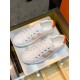 Top View Pair of White and Orange Leather Trainers Top-down view of both white leather trainers with orange accents placed side by side