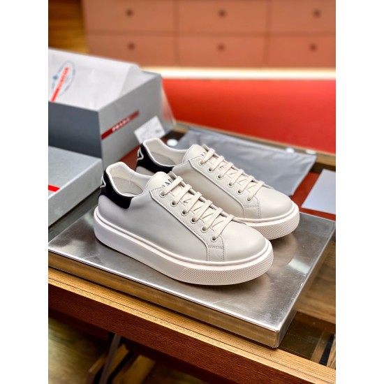 Angled front-side view of a pair of Prada Macro white and black leather trainers