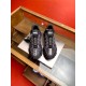 Versace Trigreca Black Trainers Front View Front perspective of both black Versace Trigreca trainers resting on a display surface