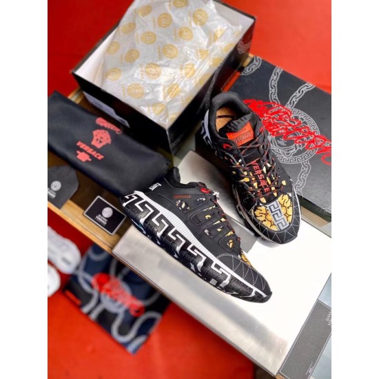 Versace Trigreca Black Trainers Packaging Set in black and yellow Top-down view of black Trigreca trainers presented with shoe box, dust bag and packaging in black and yellow