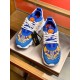 Front view of pair of Versace Chain Reaction blue baroque print low top trainers showing tongue logo patch in blue and yellow