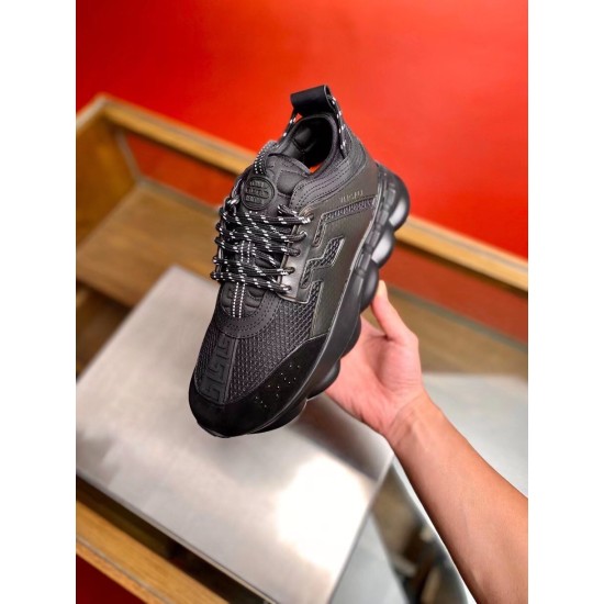 Versace Chain Reaction Black Trainer Handheld View Single black Versace Chain Reaction trainer held in hand front angle
