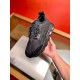 Versace Chain Reaction Black Trainer Handheld View Single black Versace Chain Reaction trainer held in hand front angle