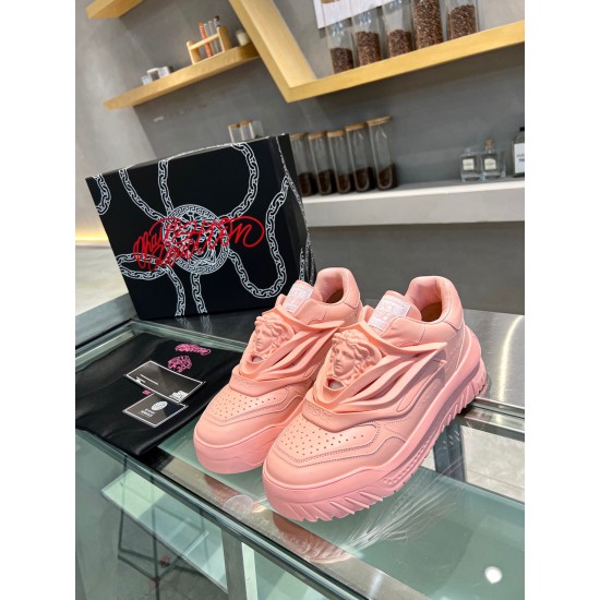 Front view of both pink Versace Odissea leather trainers showing the prominent 3D Medusa crest overlay