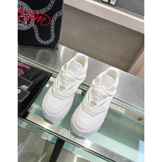 Top-down view showing tongues and Medusa details on white Versace trainers