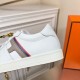 Hermes Boomerang Side Pattern Detail in white and multicoloured Close-up of the grey H motif, multicoloured stripes, and stitched heel panel in white and multicoloured
