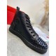 Christian Louboutin Men's Black Spiked High-Top Sneakers Inner Side View Inner side view of Christian Louboutin Men's Black Leather Spiked High-Top Sneakers with circular emblem and eyelets