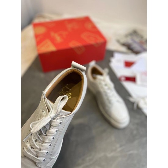 Christian Louboutin White Trainer Interior Insole Detail Interior close-up of Christian Louboutin white trainer showing foil logo on leather insole