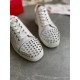 Front view highlighting the silver-spiked toe caps on the white leather trainers