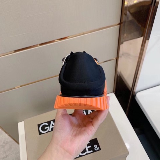 Rear view of the Dolce & Gabbana trainer displaying the black flexible heel collar and orange grooved sole heel in orange and green