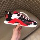 Dolce & Gabbana Red Trainer Side Profile in Hand Hand holding Dolce & Gabbana red fabric trainer showing side logo and red overlay