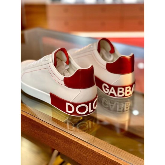 Rear view showing the bold embossed Dolce & Gabbana logo text across the red heel panels in white and red