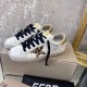 Golden Goose Low-Top Leather Trainers in white and gold Golden Goose white leather low-top trainers with black laces side-by-side view