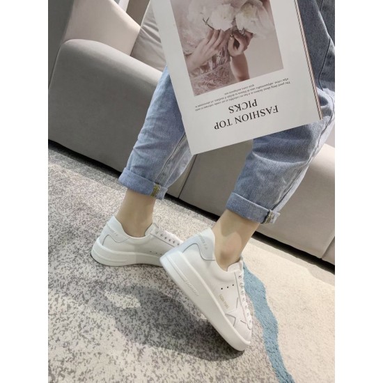 Side profile view of Golden Goose Purestar white leather trainer worn indoors