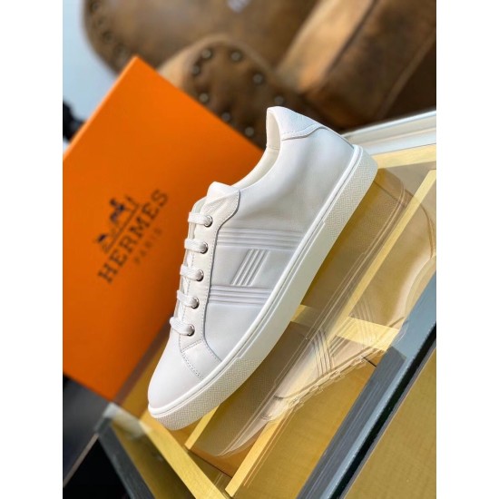 Hermes Avantage white trainer displayed with orange brand shoe box