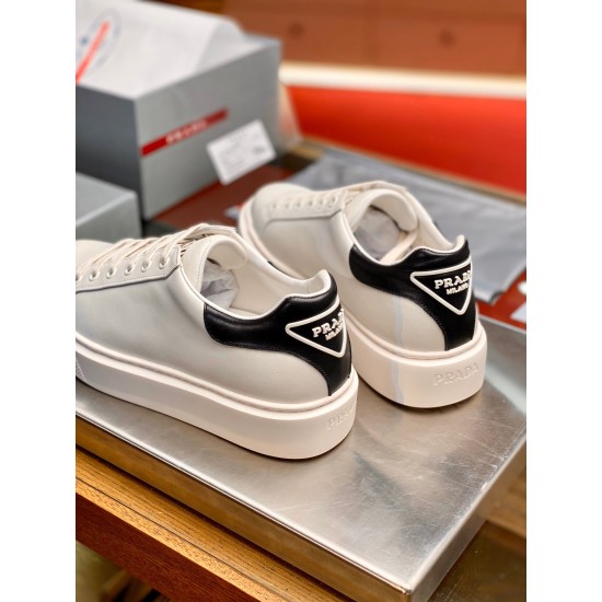 Rear view showing the black leather heel tab and logo on Prada Macro trainers in white and black