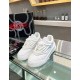 Front perspective of white leather Versace Odissea chunky trainers on glass display