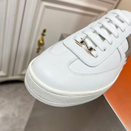 Hermes Boomerang Trainer Toe Box Detail in white and multicoloured Close-up of white leather toe box, stitched vamp, and metallic lace hardware detail in white and multicoloured