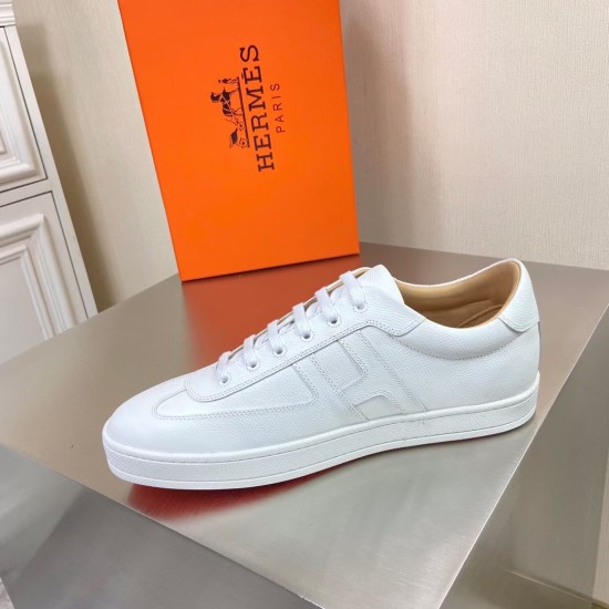 Hermes Boomerang White Low Top Trainer Lateral View Lateral side view of the left Hermes Boomerang white low-top trainer placed on a metallic table.