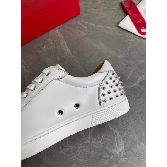 Close-up detail of the white leather upper, silver eyelets, and spiked heel counter