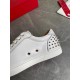 Close-up detail of the white leather upper, silver eyelets, and spiked heel counter