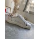 Lateral side view of a single Christian Louboutin Vieirissima white leather trainer resting on grey marble surface in white and black