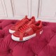 Dolce & Gabbana Custom 2.Zero Red Trainers Pair View Pair of Dolce & Gabbana Custom 2.Zero red trainers resting on red tufted surface